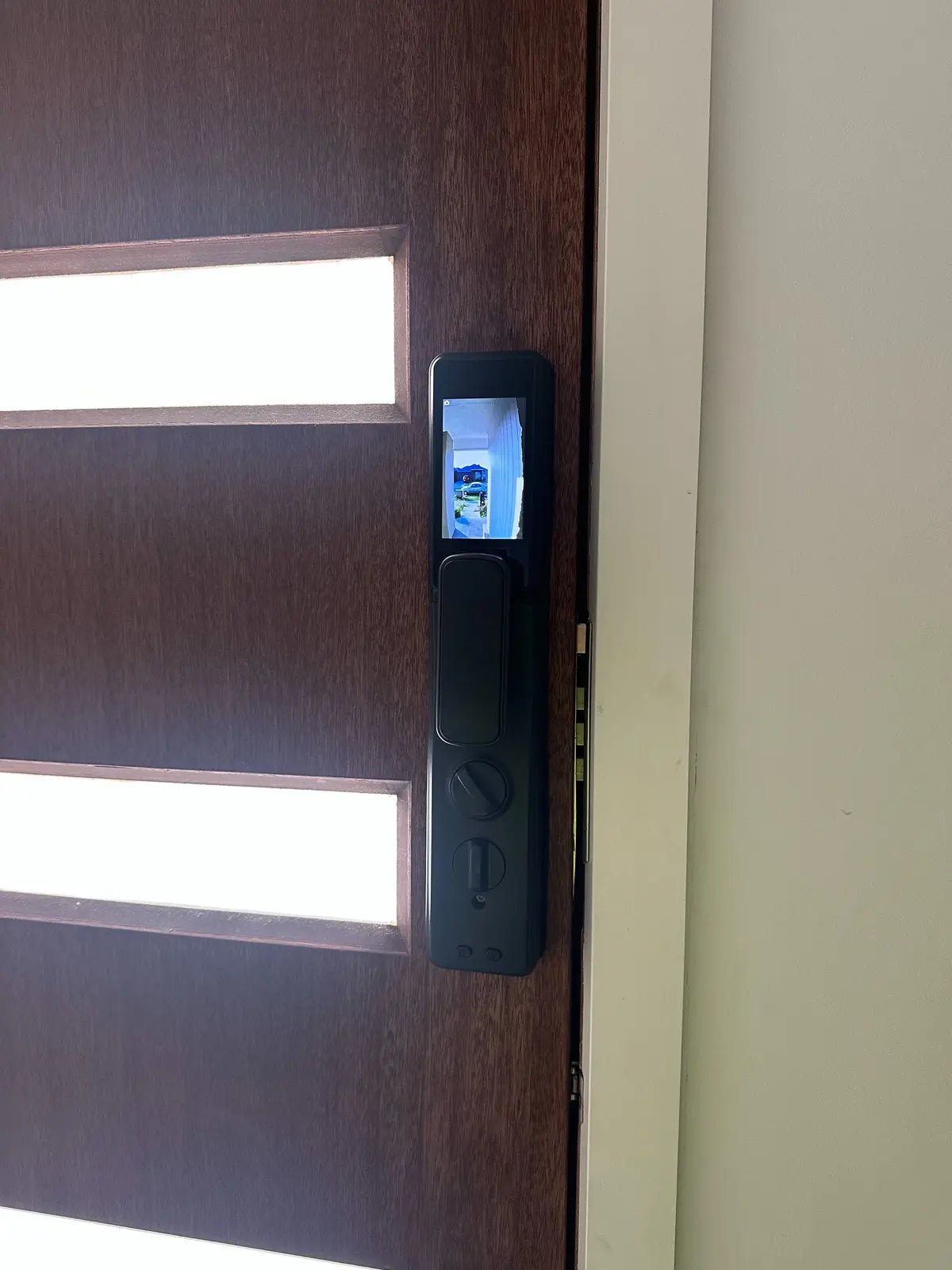 Illuminated smart lock on a mahogany entrance door