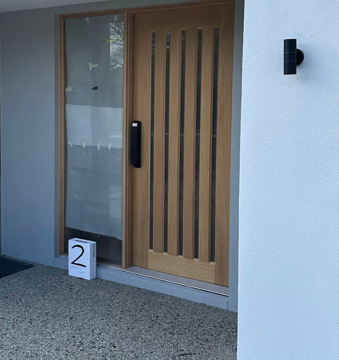 Completed smart-lock installation at a modern timber entrance
